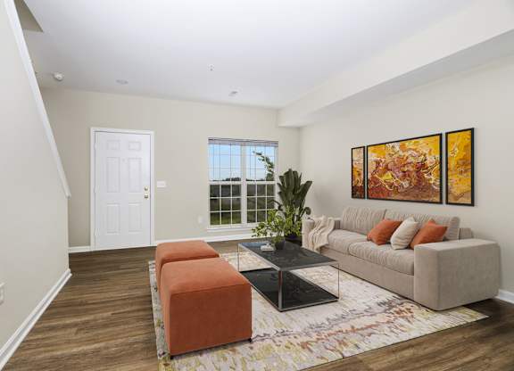 A living room with a couch, a coffee table, and a rug.
